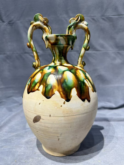 Tang Sancai double - dragon - handled vase. With ancient charm and flowing colors, it is exquisitely hand - crafted. Its unique shape and rare beauty make it an excellent choice for collectors!